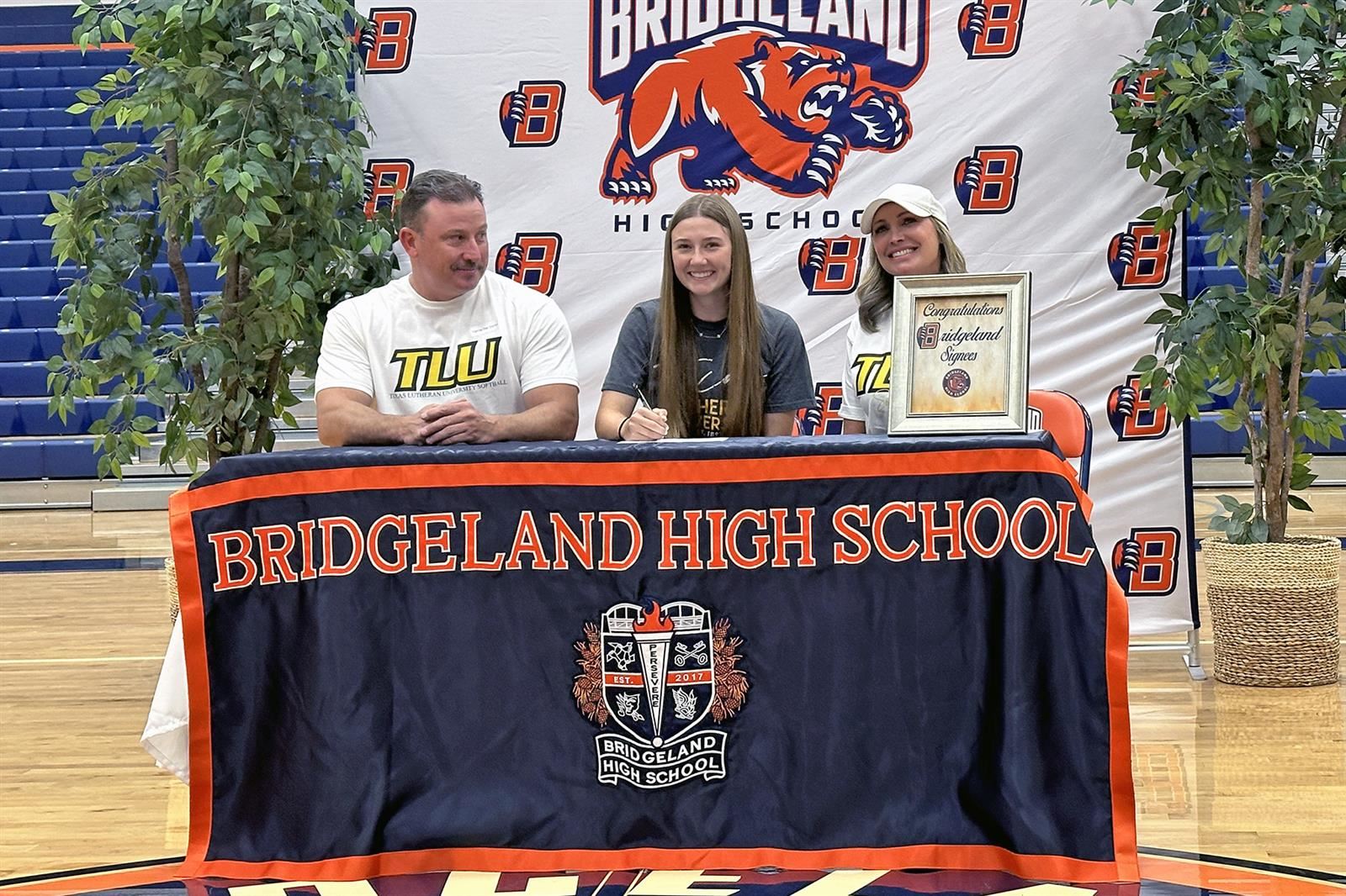 Bridgeland High School senior Chesley Swisher, center, signed her letter of intent to play softball at Texas Lutheran.